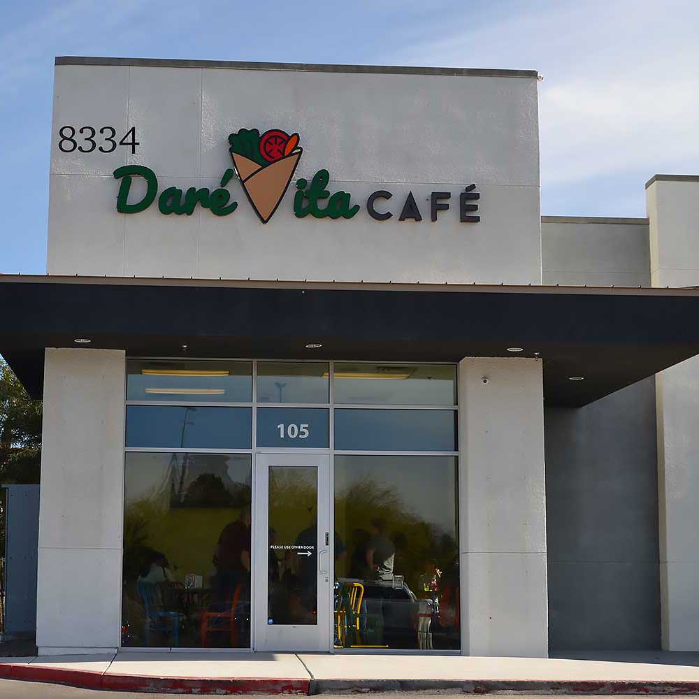 sign-for-hompage The exterior of Daré Vita Café, featuring a modern design with large glass windows and a logo highlighting fresh produce, offers vibrant, allergen-friendly, and plant-based meals in a welcoming setting for healthy living enthusiasts.| Daré Vita Café | Las Vegas