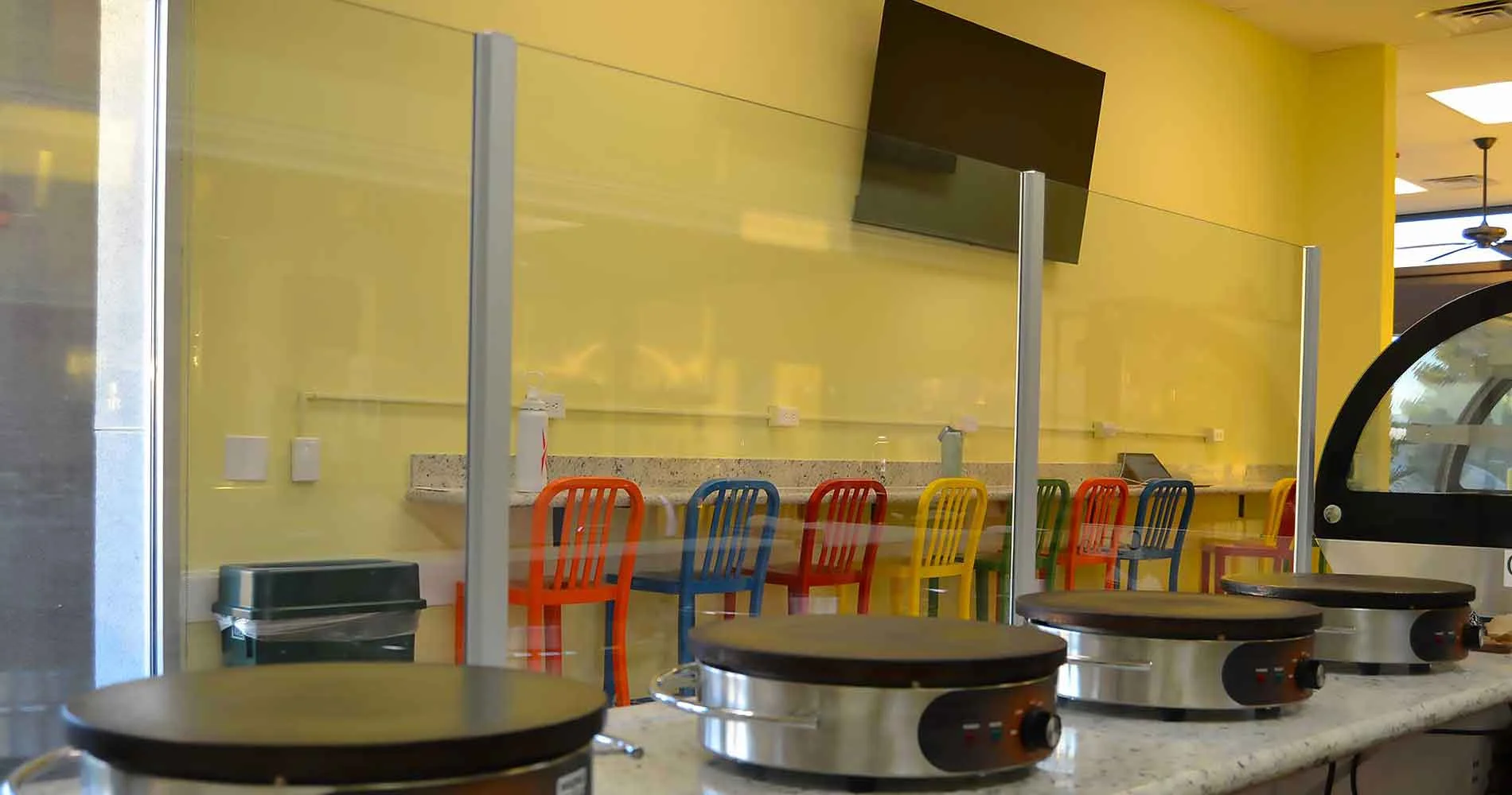Inside Daré Vita Café, a modern setting with colorful chairs and crepe makers on a counter. The café offers allergen-friendly, plant-based dishes made with fresh ingredients, promoting healthy living in a vibrant environment.| Daré Vita Café | Las Vegas